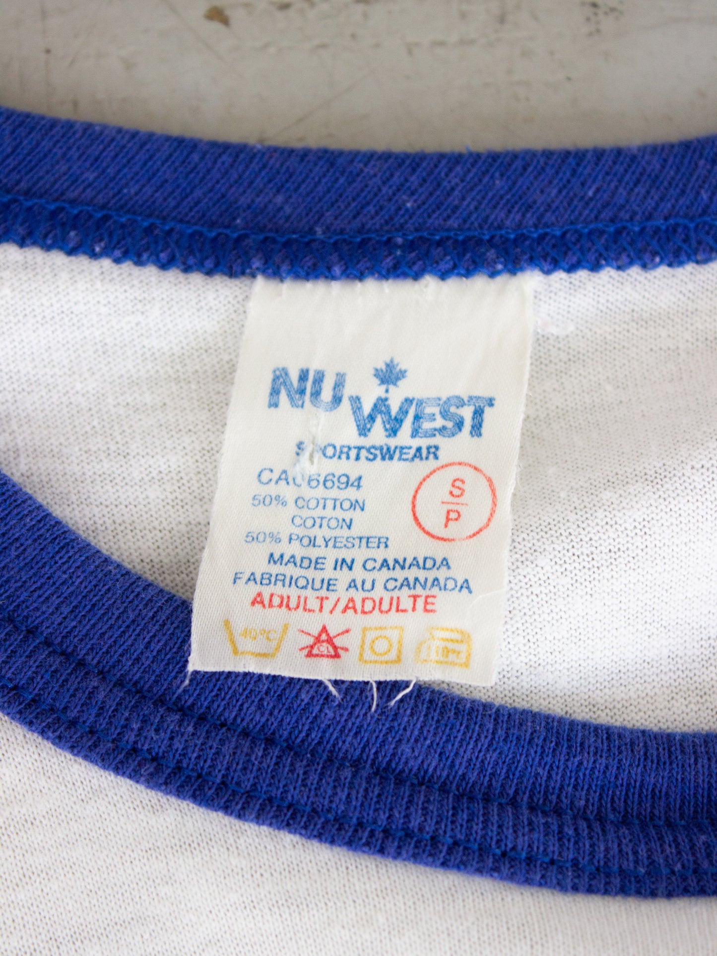 1983 Men at Work 'Cargo' North America Tour, White and Blue Raglan Tee (Small-Medium)